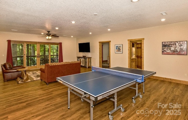 game room featuring recessed lighting, baseboards, a textured ceiling, and wood finished floors