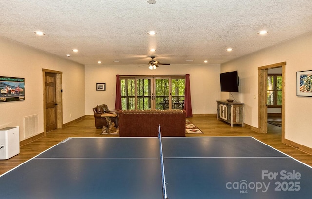 playroom with visible vents, recessed lighting, a textured ceiling, and wood finished floors