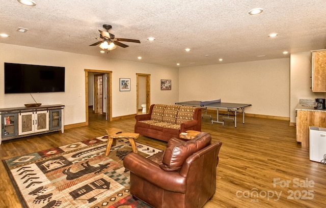 living room featuring recessed lighting, a textured ceiling, wood finished floors, and a ceiling fan