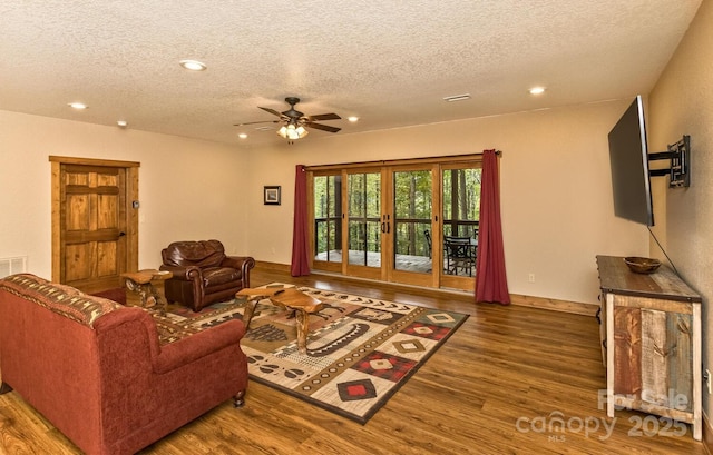 living area featuring ceiling fan, recessed lighting, french doors, wood finished floors, and a textured ceiling