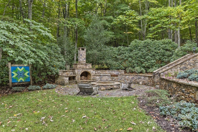 view of yard with an outdoor stone fireplace