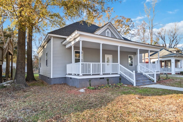 view of front of property featuring a porch, roof with shingles, and crawl space