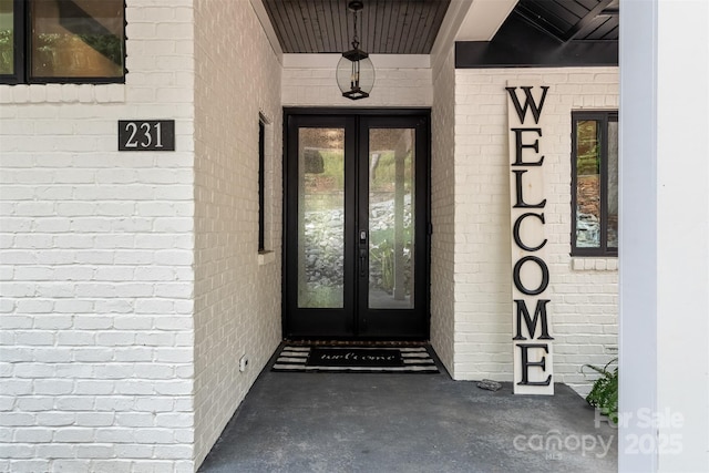 entrance to property with french doors and brick siding