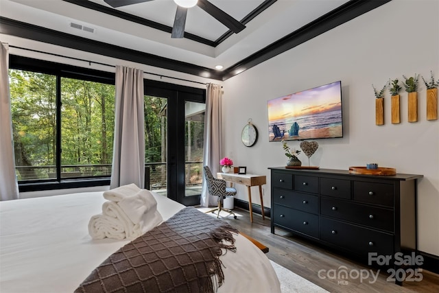 bedroom with visible vents, ceiling fan, ornamental molding, wood finished floors, and access to outside