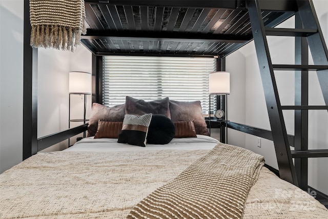 bedroom with beam ceiling