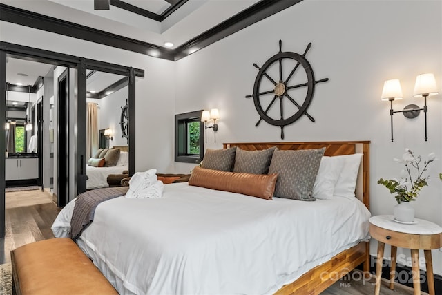 bedroom with wood finished floors and ornamental molding