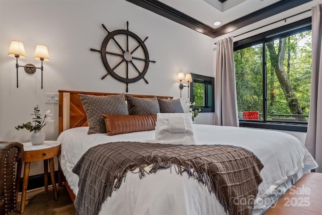 bedroom featuring crown molding and wood finished floors