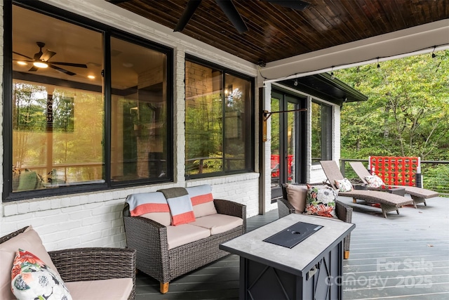 wooden terrace with an outdoor hangout area