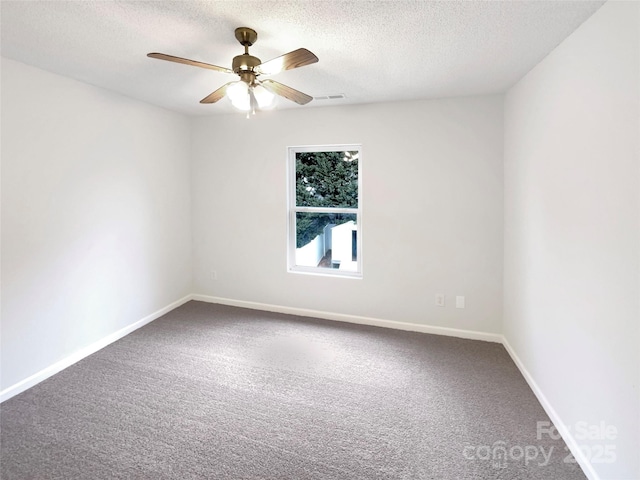 carpeted empty room with visible vents, baseboards, a textured ceiling, and ceiling fan