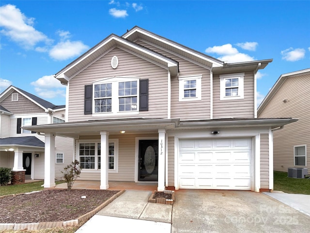 view of front of house with a porch, a garage, and driveway