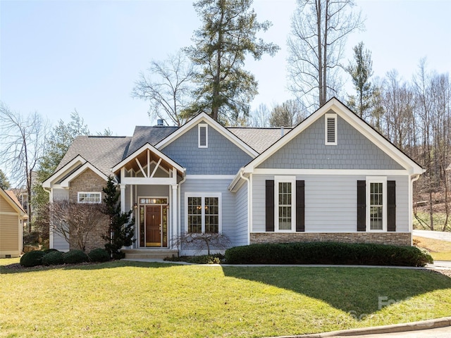 craftsman inspired home with stone siding and a front lawn