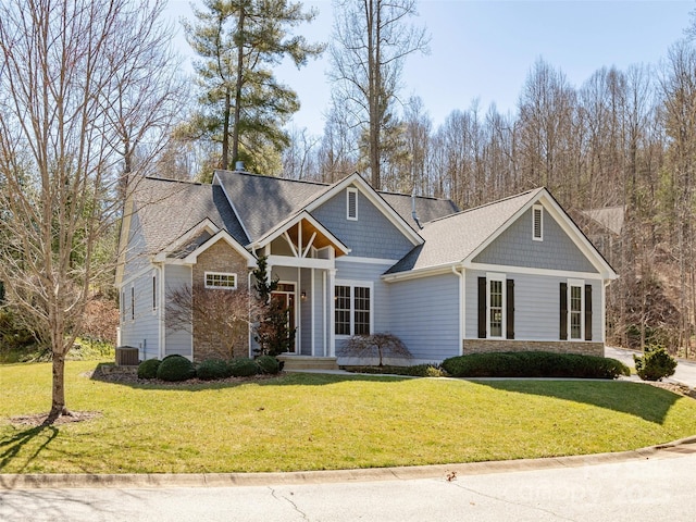 craftsman-style home with stone siding and a front lawn