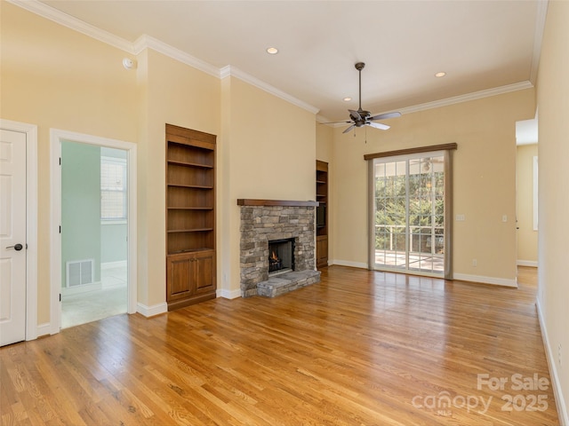 unfurnished living room featuring visible vents, a fireplace, light wood-type flooring, and crown molding