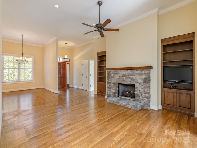 unfurnished living room featuring crown molding, light wood-style floors, and baseboards