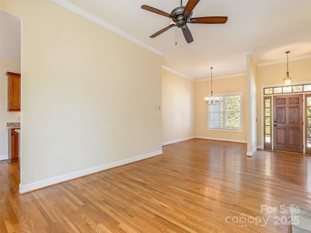 unfurnished living room with ceiling fan with notable chandelier, baseboards, light wood finished floors, and ornamental molding