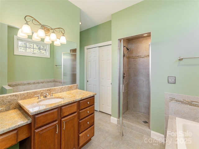 bathroom featuring vanity, a bath, a stall shower, and tile patterned flooring