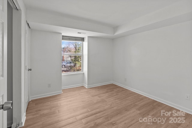 unfurnished bedroom featuring light wood-style flooring, visible vents, and baseboards