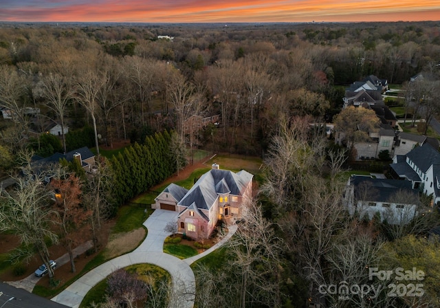 bird's eye view featuring a wooded view