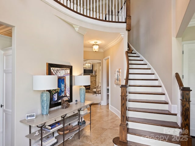 entryway featuring stairs, crown molding, and baseboards