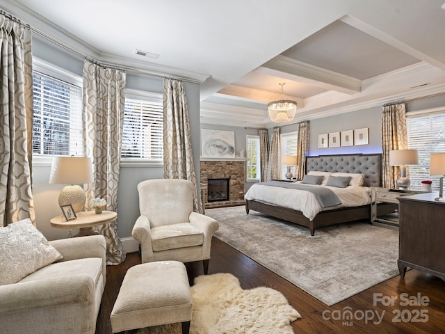 bedroom featuring visible vents, multiple windows, wood finished floors, and crown molding