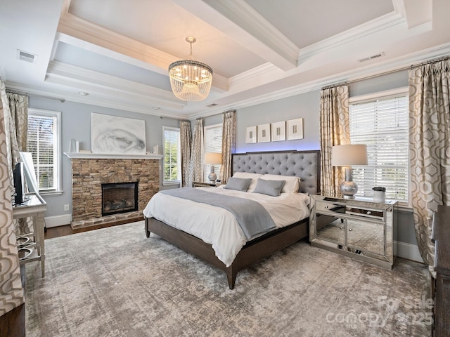 bedroom featuring visible vents, an inviting chandelier, a fireplace, and crown molding