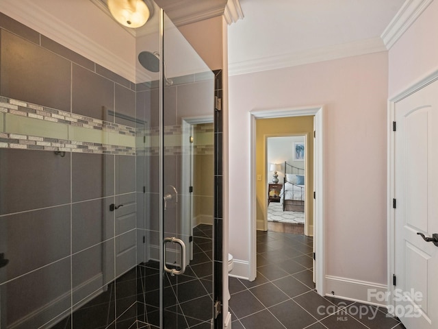 bathroom with tile patterned floors, baseboards, a stall shower, and ornamental molding