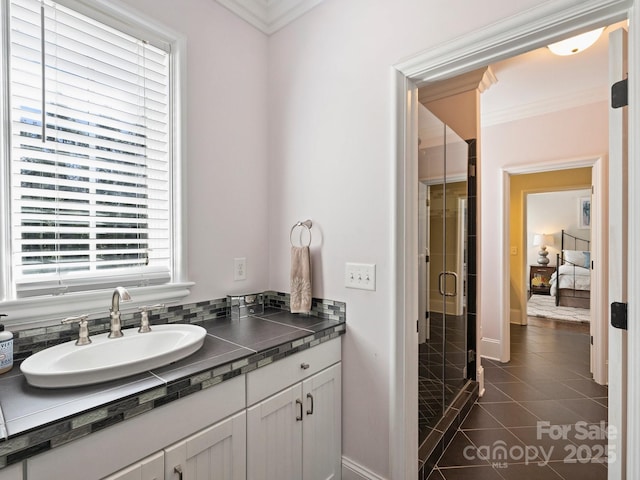 ensuite bathroom featuring crown molding, a stall shower, ensuite bathroom, tile patterned floors, and vanity