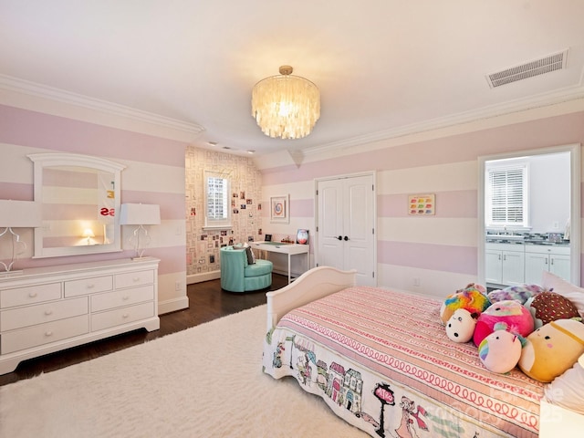 bedroom with a chandelier, visible vents, crown molding, and wood finished floors