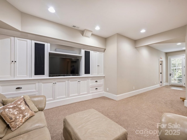 living area with recessed lighting, visible vents, light colored carpet, and baseboards