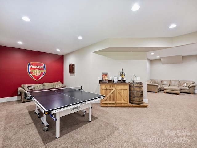 game room with recessed lighting, baseboards, light carpet, and wet bar