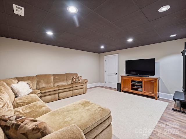 living area with recessed lighting, visible vents, light wood-style flooring, and baseboards