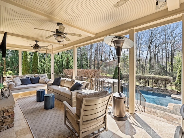 view of patio featuring outdoor lounge area, a fenced in pool, fence, and ceiling fan