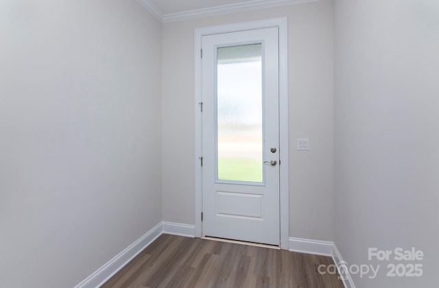 doorway to outside with a wealth of natural light, crown molding, baseboards, and dark wood-style flooring