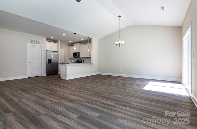 unfurnished living room featuring visible vents, baseboards, dark wood-style flooring, and vaulted ceiling