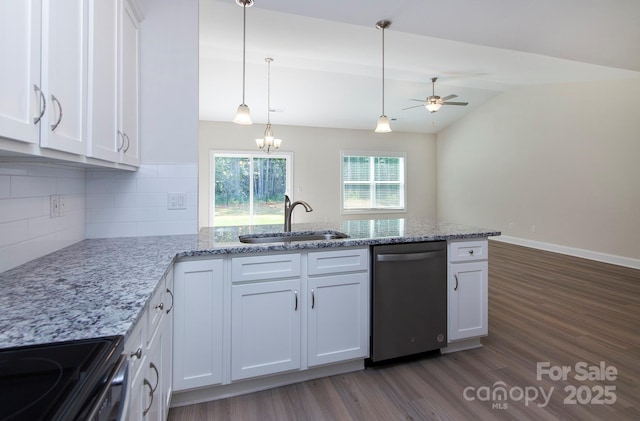 kitchen with a peninsula, a sink, vaulted ceiling, white cabinets, and dishwasher