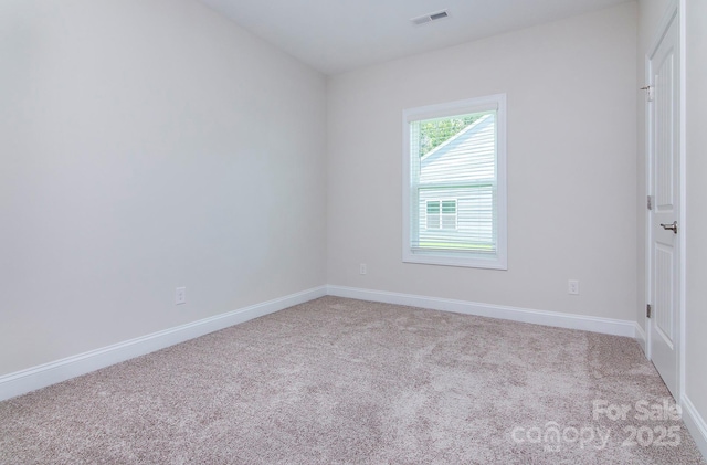 unfurnished room with visible vents, carpet flooring, and baseboards