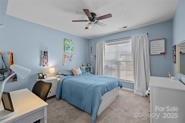 bedroom featuring ceiling fan, baseboards, visible vents, and light carpet