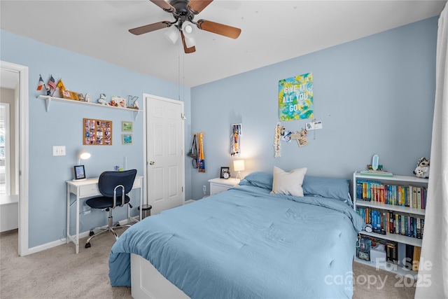 bedroom featuring baseboards, carpet floors, and a ceiling fan