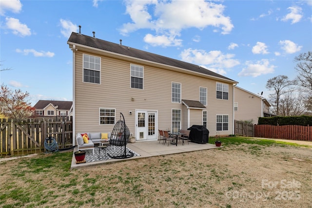 back of house featuring a patio area, a yard, a fenced backyard, and a gate