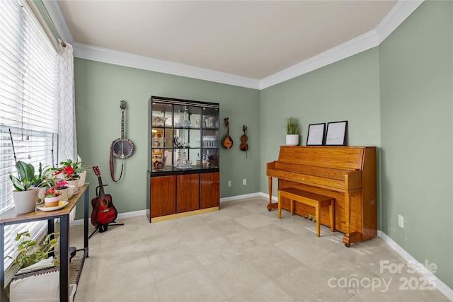 sitting room with crown molding and baseboards