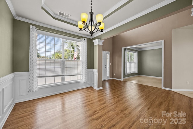252 Legend Dr, Rock Hill, SC 29732 - unfurnished dining area with a chandelier, wood finished floors, crown molding, a tray ceiling, and ornate columns