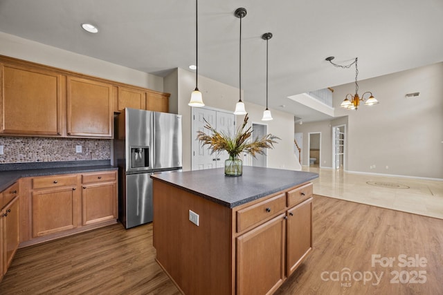 252 Legend Dr, Rock Hill, SC 29732 - kitchen with stainless steel fridge with ice dispenser, dark countertops, tasteful backsplash, and wood finished floors