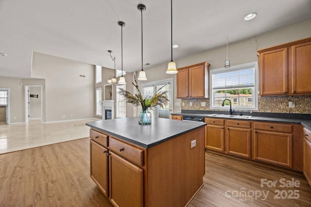 252 Legend Dr, Rock Hill, SC 29732 - kitchen featuring dark countertops, a sink, light wood-type flooring, brown cabinetry, and recessed lighting