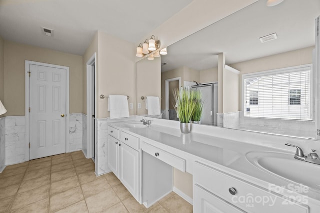252 Legend Dr, Rock Hill, SC 29732 - full bath featuring double vanity, a wainscoted wall, a stall shower, tile patterned flooring, and tile walls