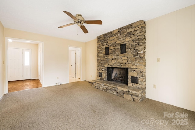 unfurnished living room featuring a fireplace, a ceiling fan, and carpet