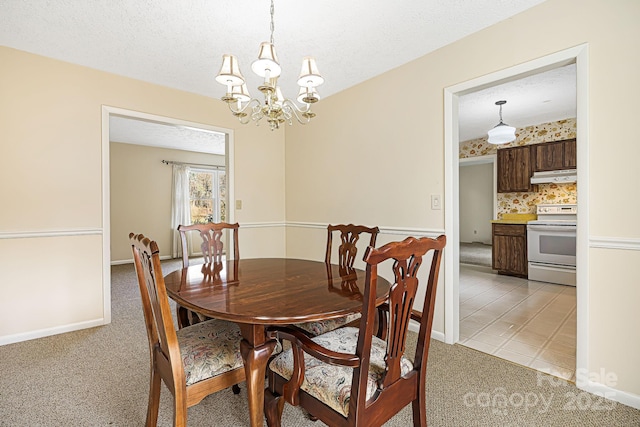 dining room with light carpet, a notable chandelier, a textured ceiling, and baseboards