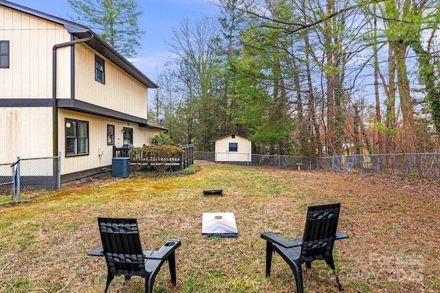 view of yard featuring a fenced backyard, a deck, and central AC