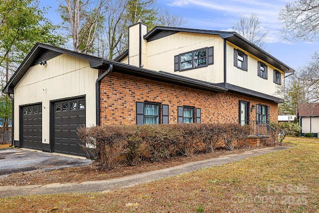 view of property exterior featuring aphalt driveway, an attached garage, brick siding, and a chimney