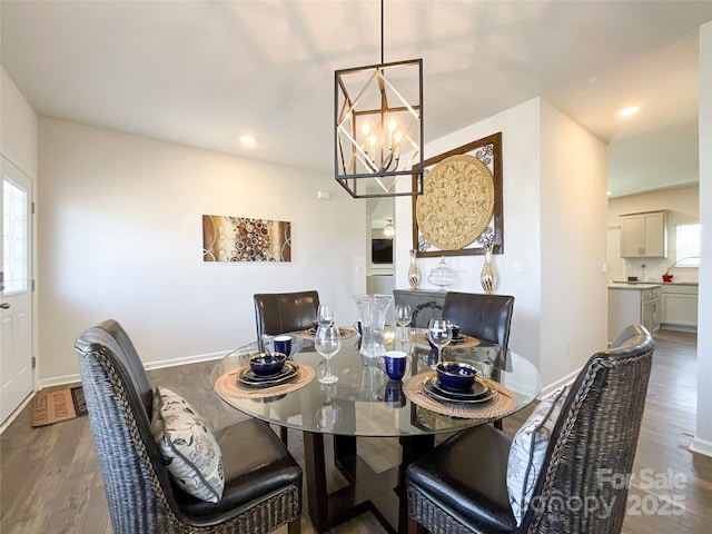 dining area featuring recessed lighting, a notable chandelier, wood finished floors, and baseboards