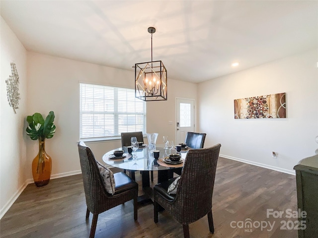 dining area featuring a notable chandelier, dark wood-style floors, and baseboards